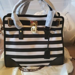 Brand new Authentic Michael Kors with Tags. Never carried, closet kept dust bag.